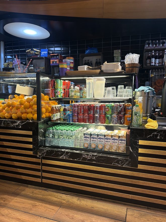 Cakes, snacks and cold drinks in the cafe's display counter and fridge